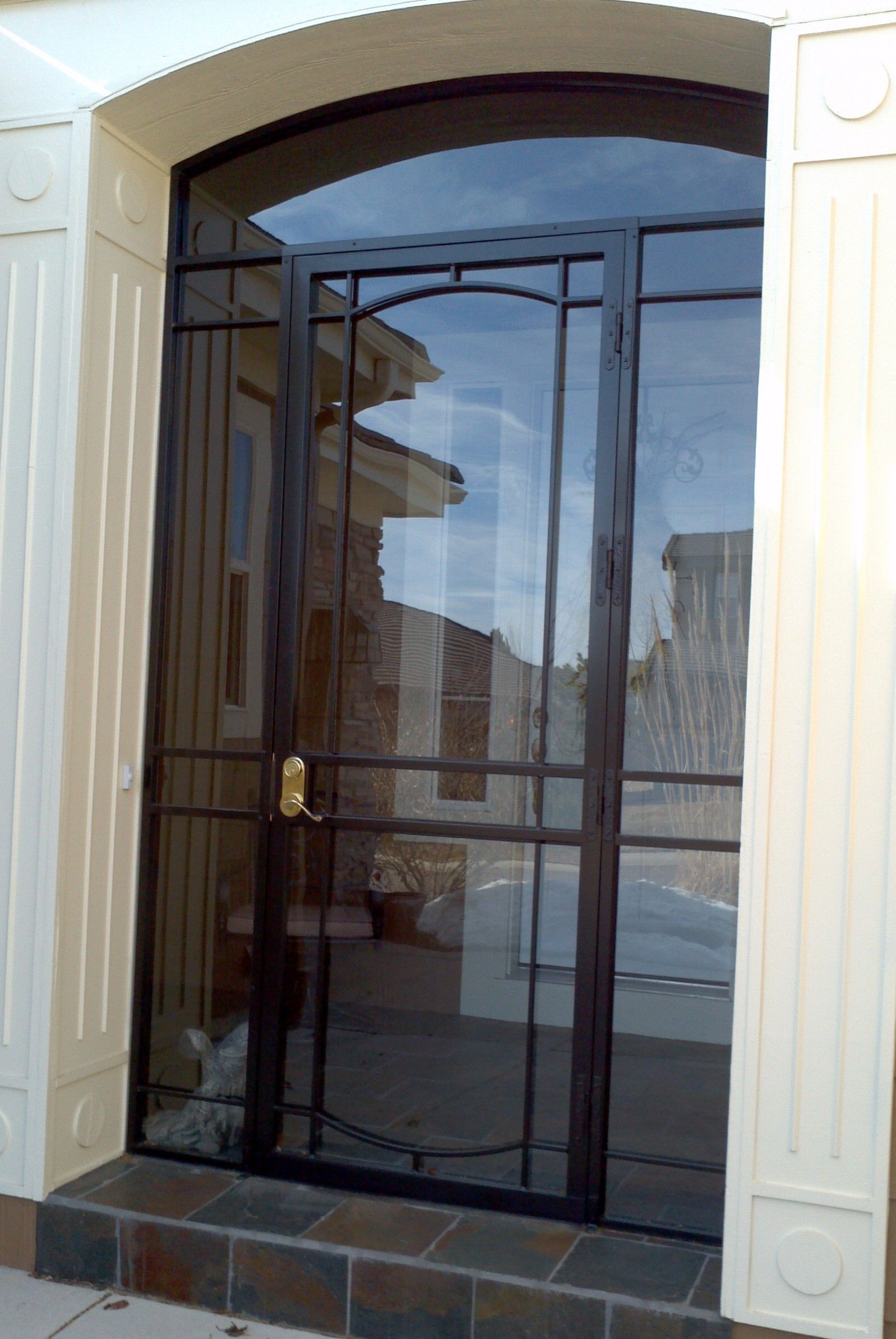 A door with a reflection of a building in it