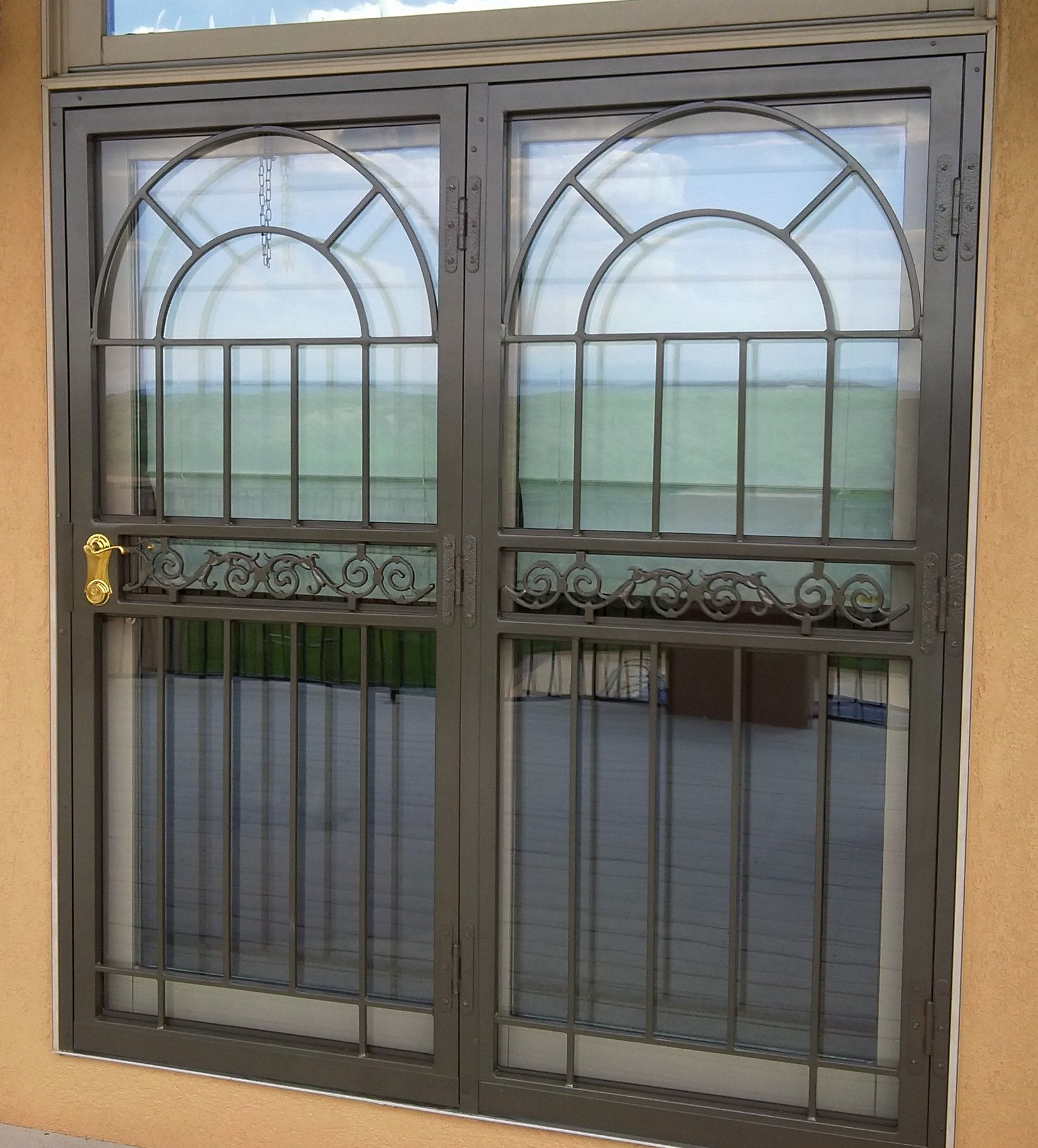 A window with a wrought iron fence around it