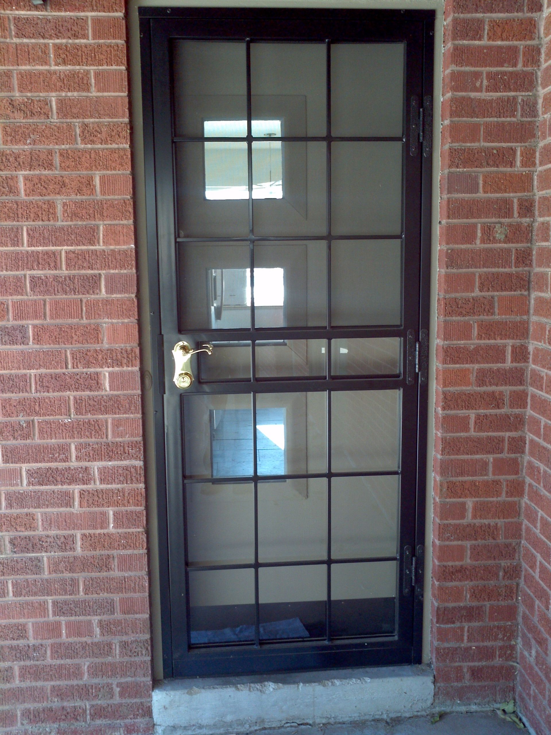A brick building with a black door and a window