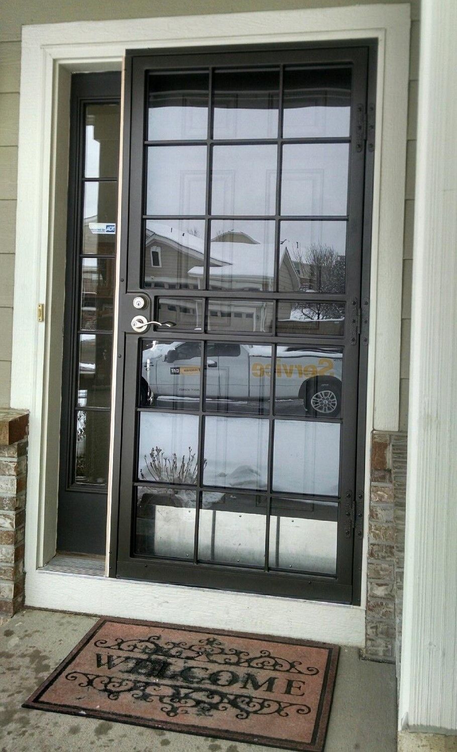 A door with a welcome mat in front of it.
