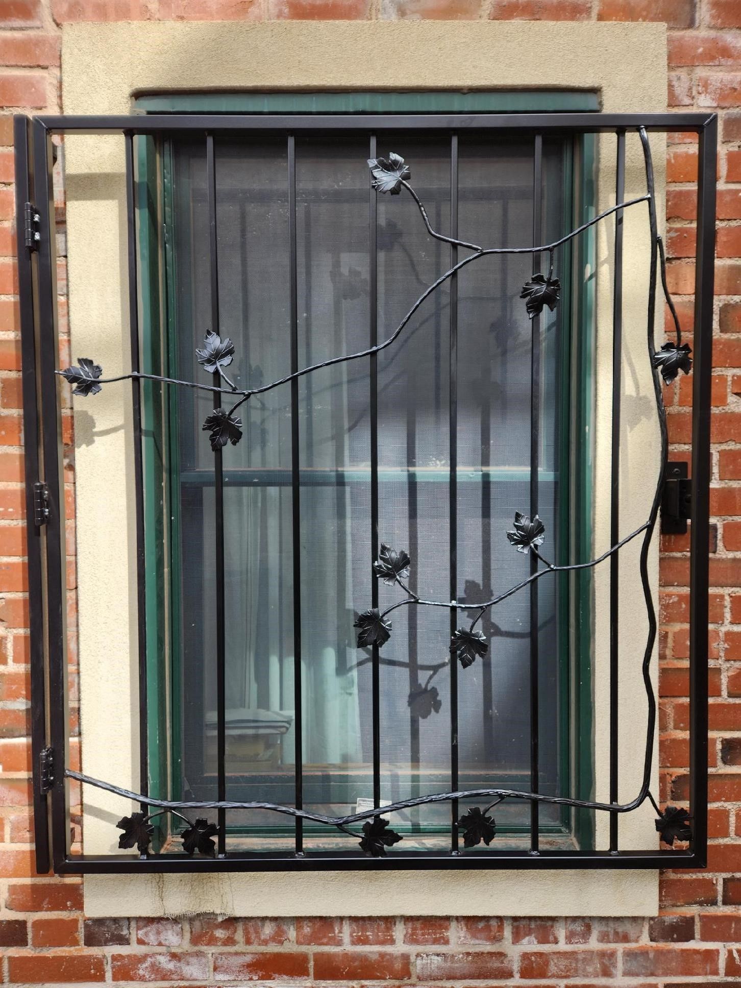 A window with a wrought iron fence around it