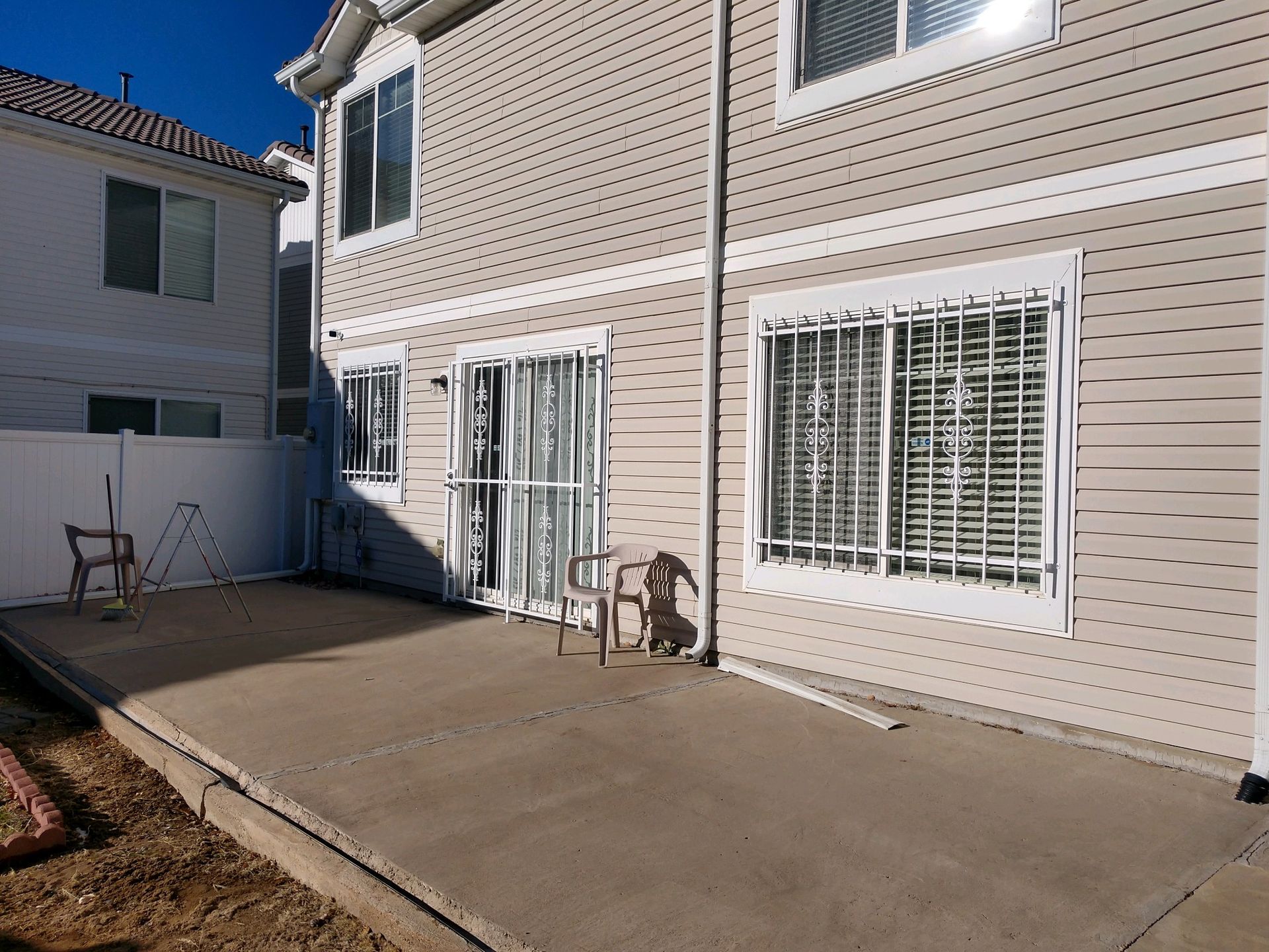 A house with a patio and chairs in front of it.