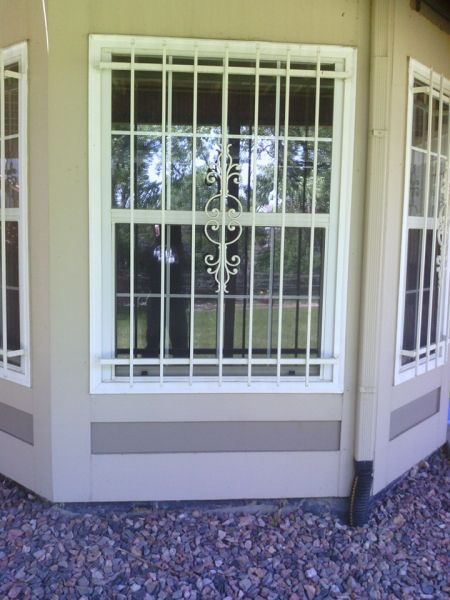 A window with a wrought iron grille on it