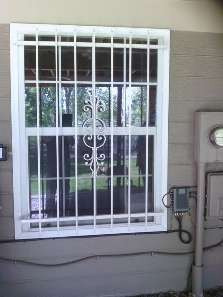 A window with a wrought iron grille on it