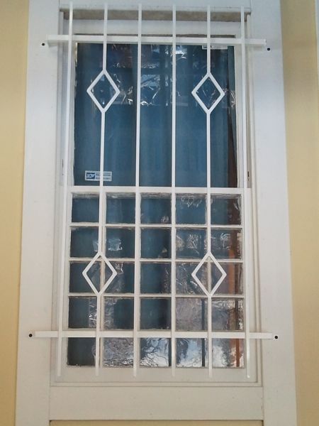 A window with a wrought iron grille on it