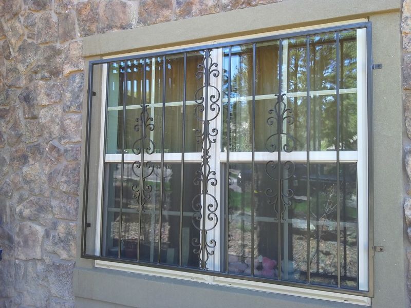 A window with a wrought iron grille on it