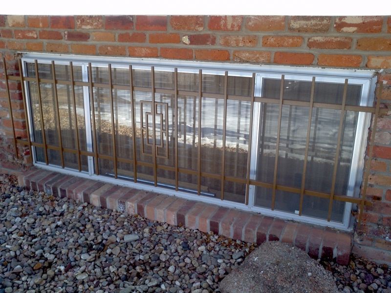 A brick wall with a window with bars on it