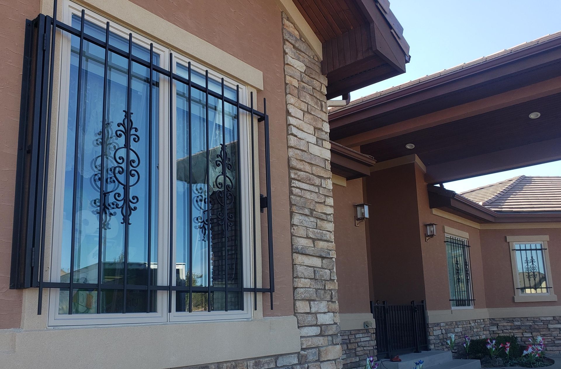 A house with a window with a wrought iron grille on it