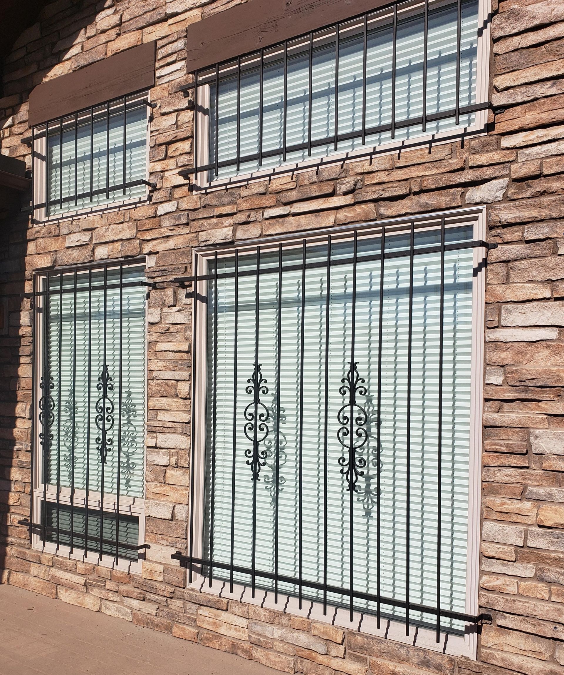 A brick building with a wrought iron fence around the windows