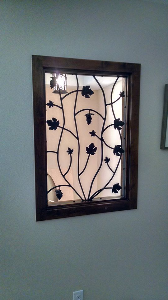 A window with a wrought iron design on it