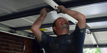 Man repairing a garage door opener