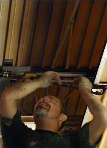 Man repairing a broken garage door spring