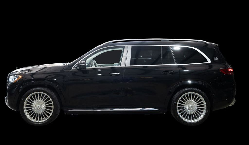 Black Mercedes-Maybach GLS SUV with chrome accents and wheels, on black background.