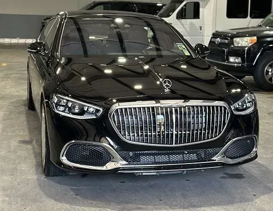 Black Mercedes-Maybach with chrome grille parked in a garage.