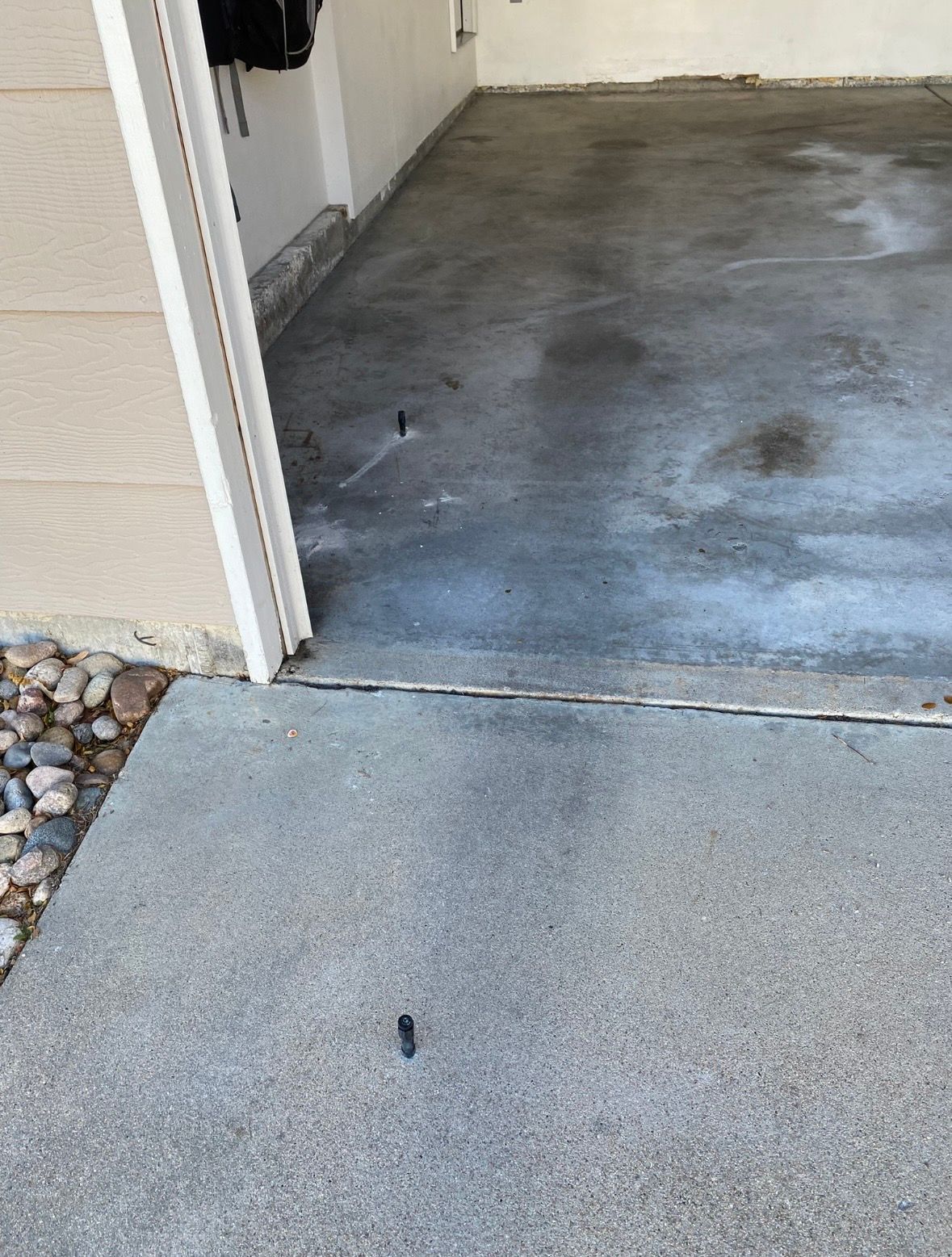 Exterior doorway leads to a garage with a concrete floor.