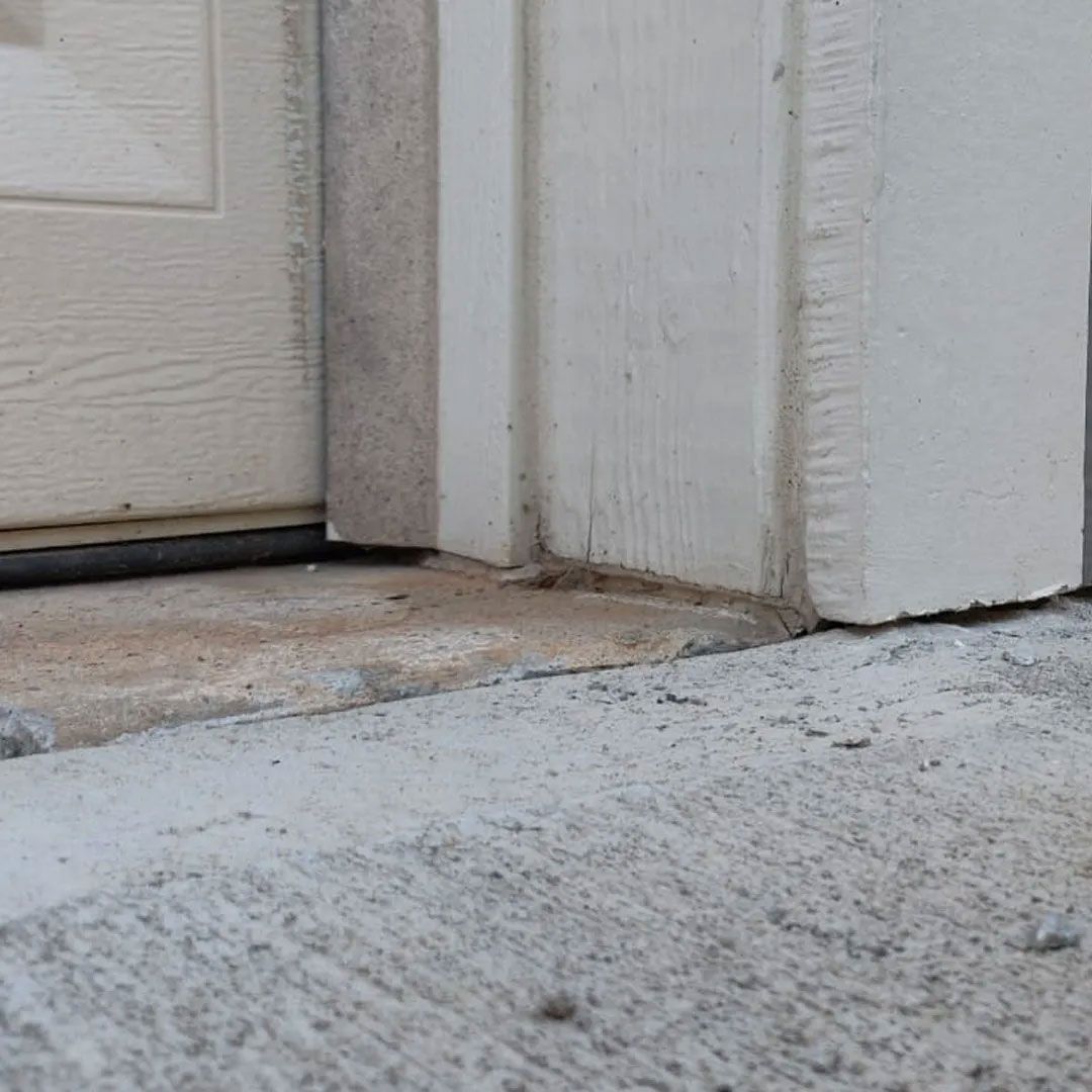 Concrete threshold at base of door frame.