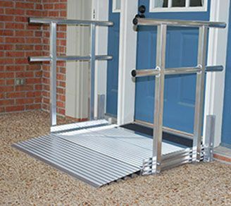 A metal ramp is sitting in front of a blue door.