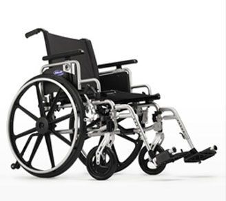 A black and silver wheelchair is sitting on a white surface.