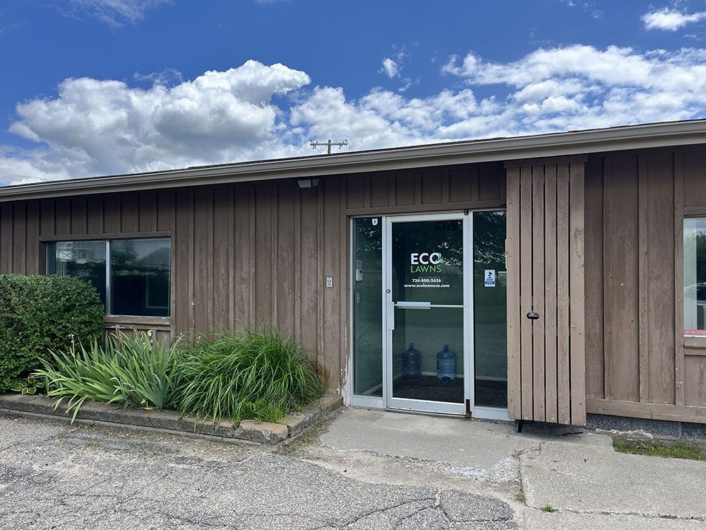 The front of a wooden building with a glass door.