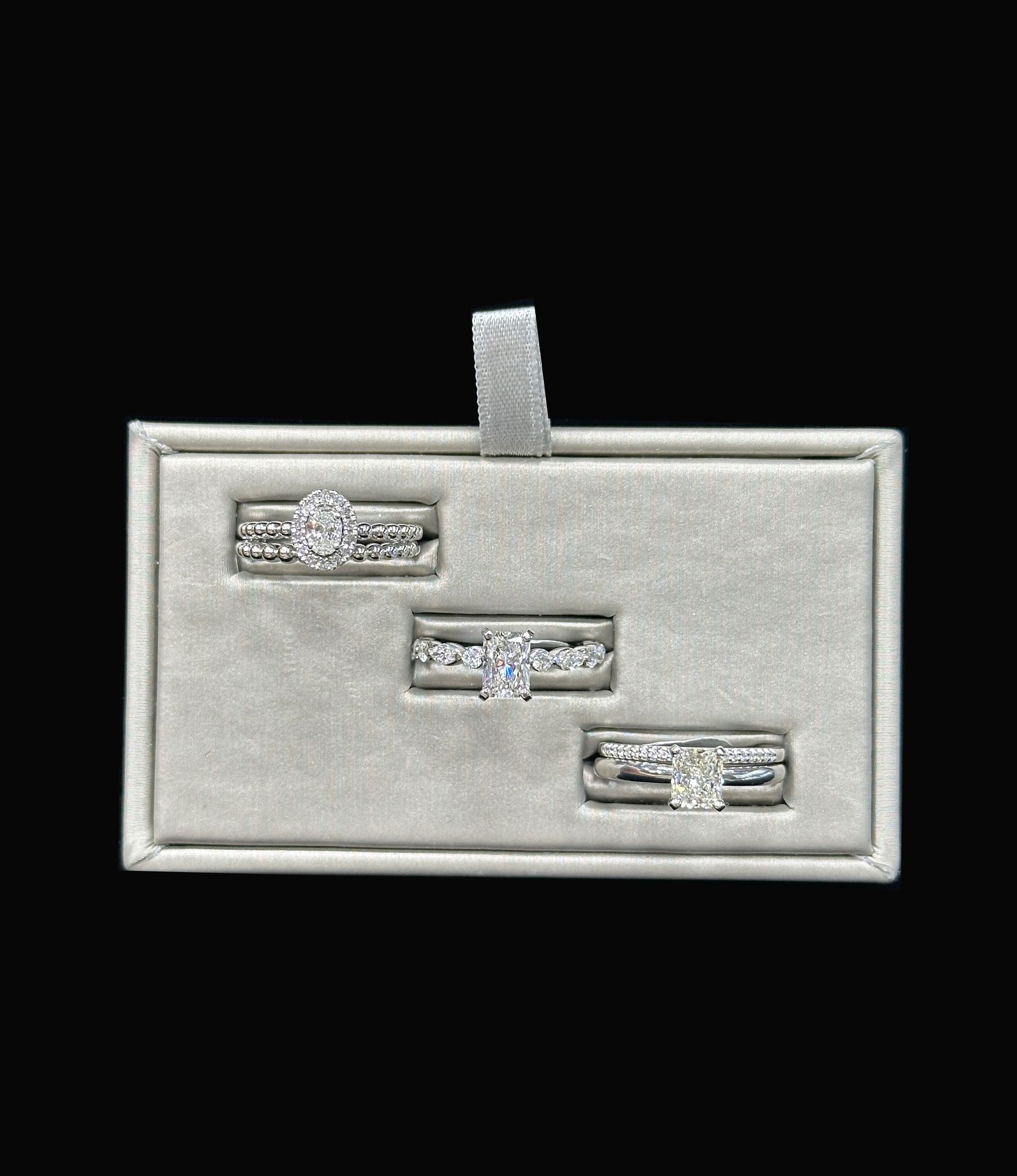 A box with three rings in it on a black background.
