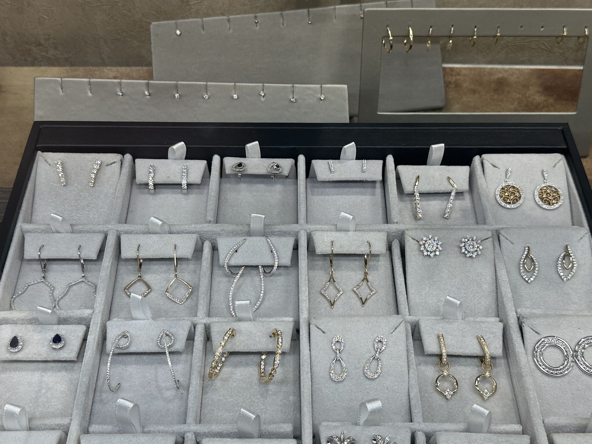 A display case filled with earrings and necklaces
