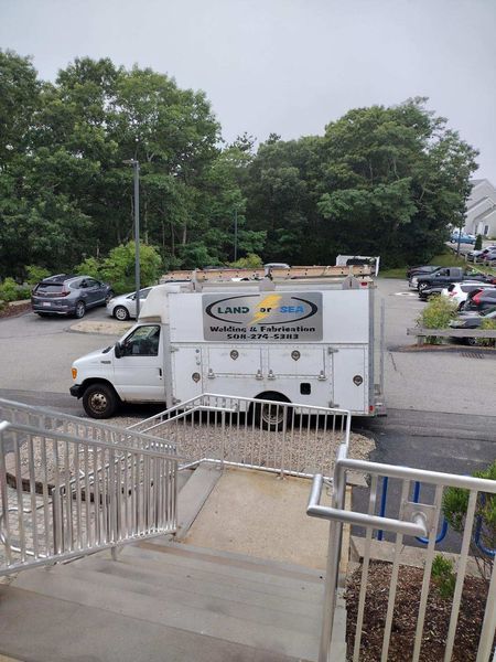 White service truck in a parking lot, with a logo that says 