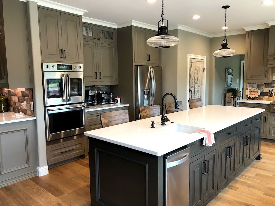 A kitchen with a large island and stainless steel appliances.