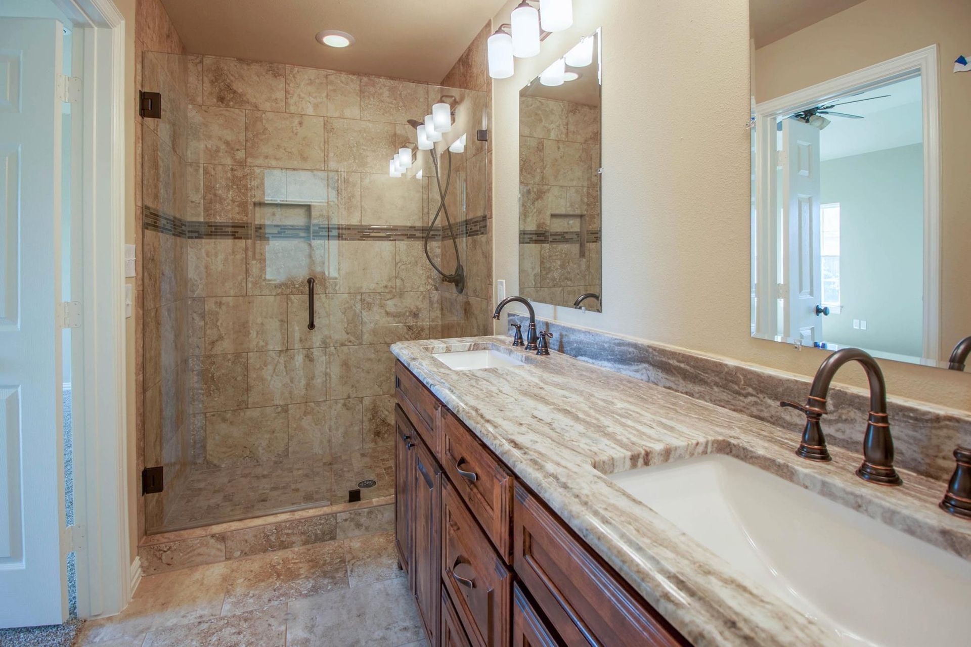 A bathroom with a sink, toilet, and mirror