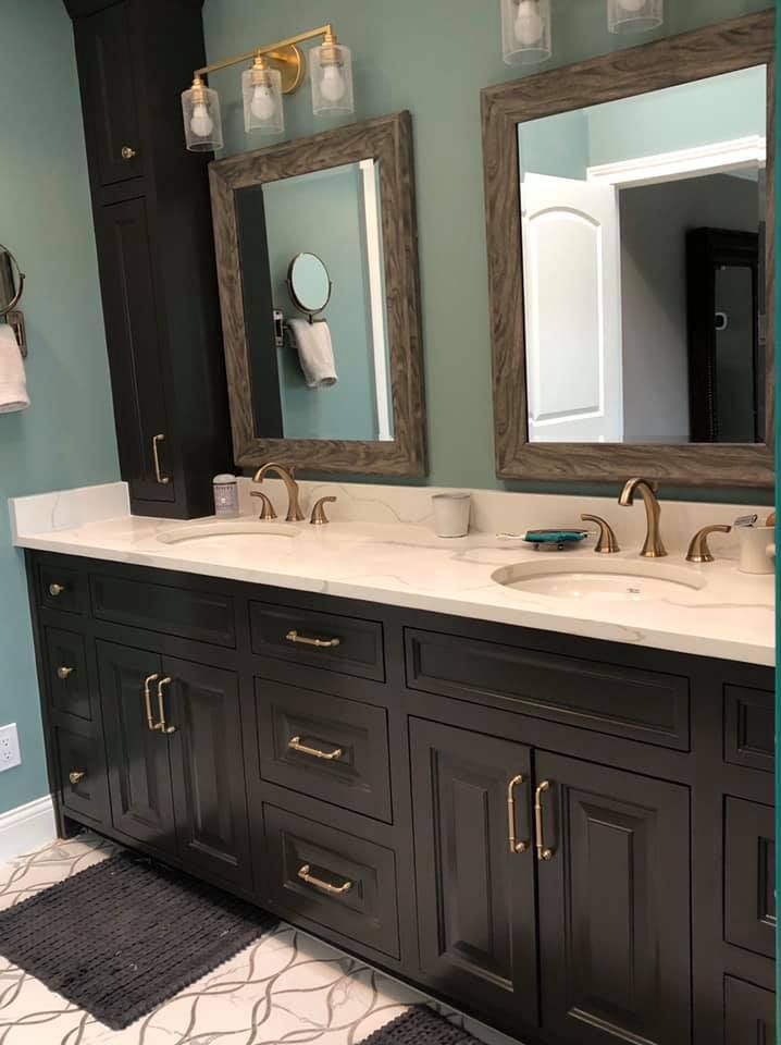 A bathroom with two sinks and two mirrors