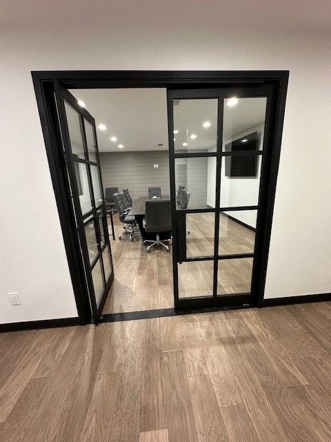 Room with black glass doors