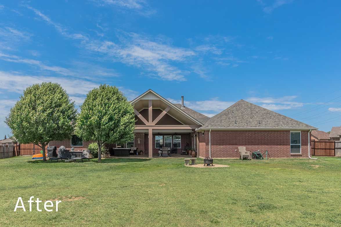 Brick house with a huge yard and covered patio