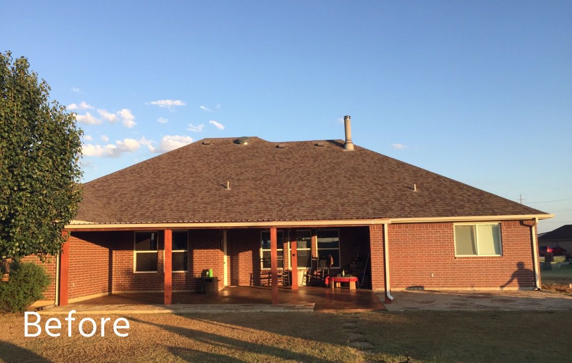 A house with a covered patio and a pool in front of it