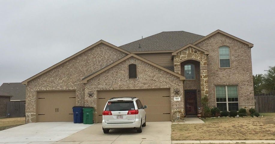 A large brick house with two garage doors