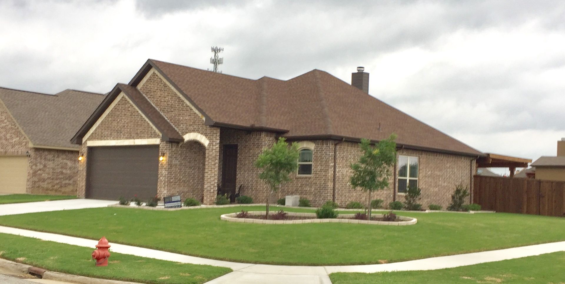 Huge brick house with a well-trimmed lawn