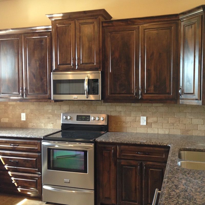 Kitchen with dark wooden cabinets and granite countertops