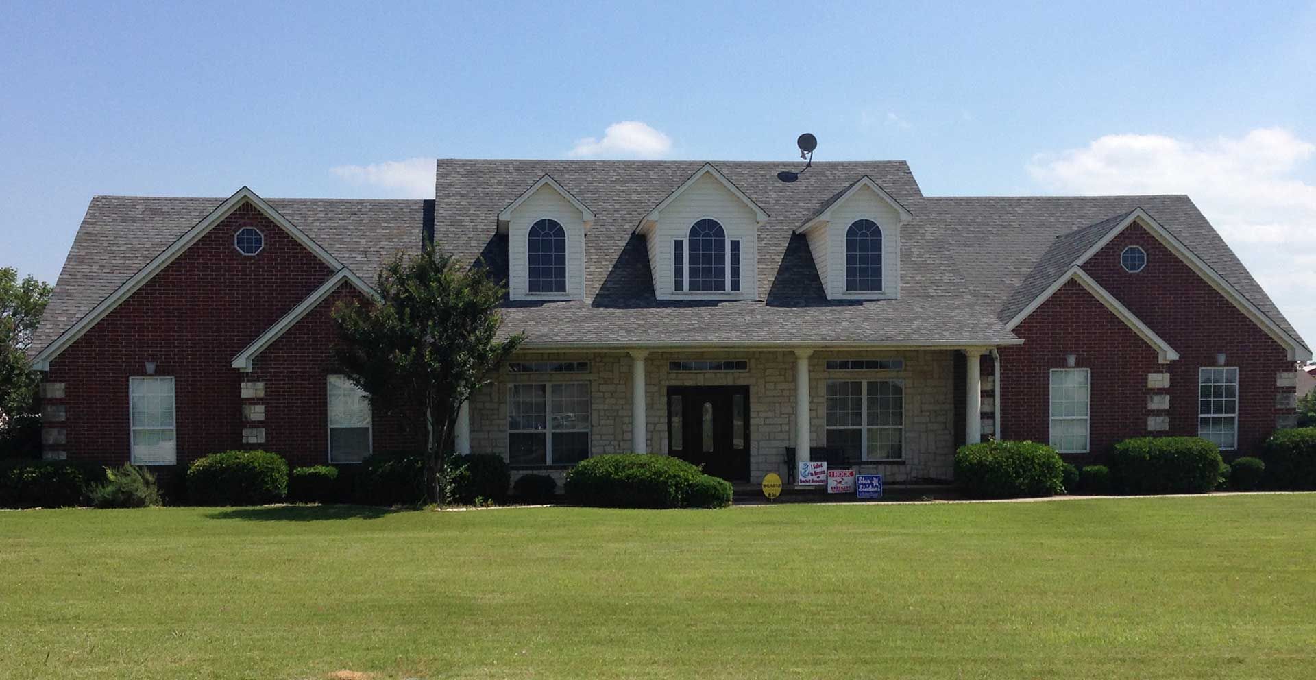 Huge house with dormer windows a huge lawn