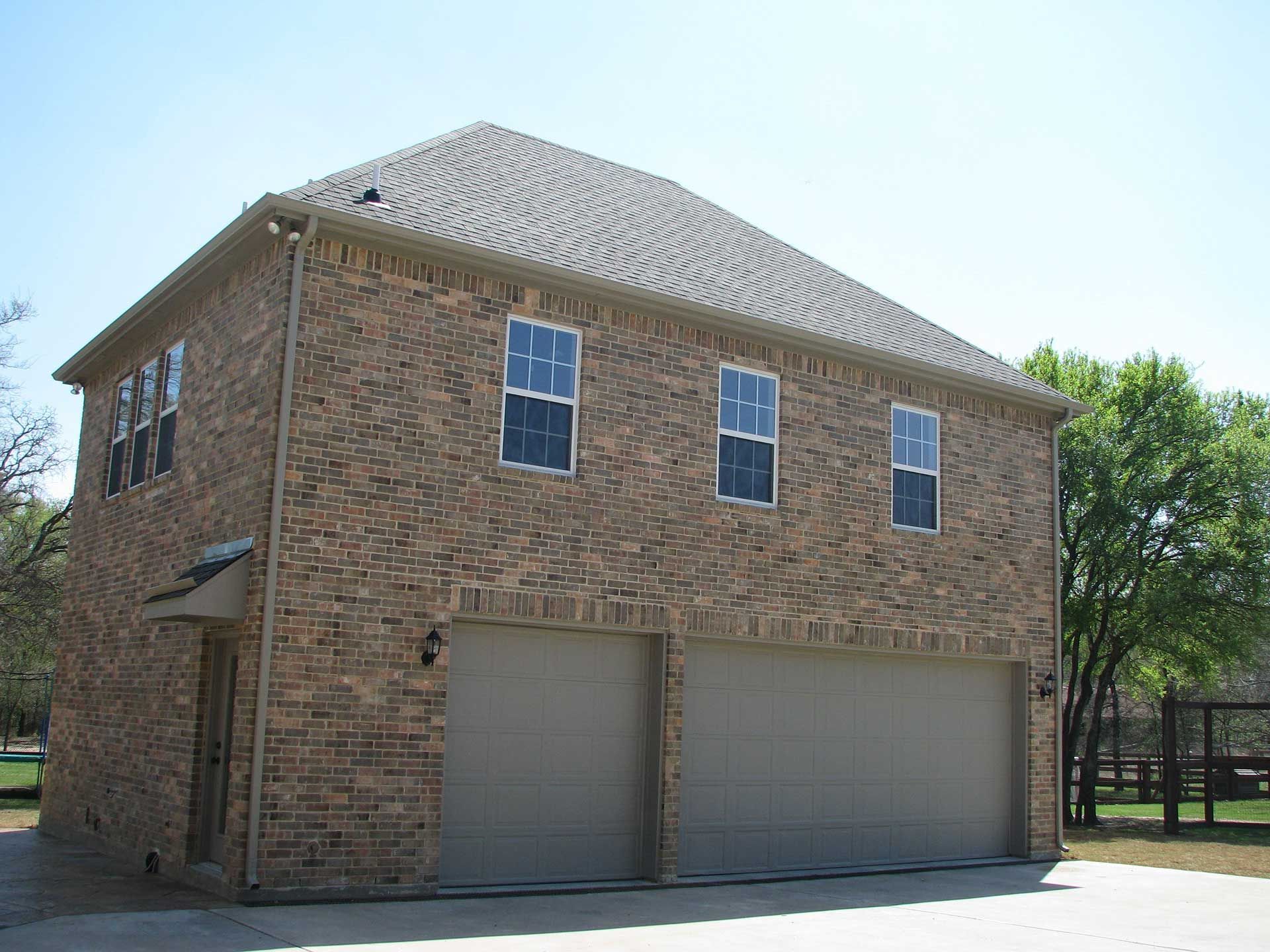 A large brick house with two garage doors