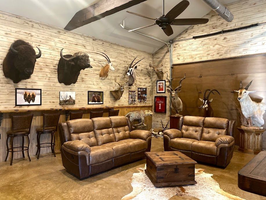 A living room with couches, a coffee table, and a ceiling fan