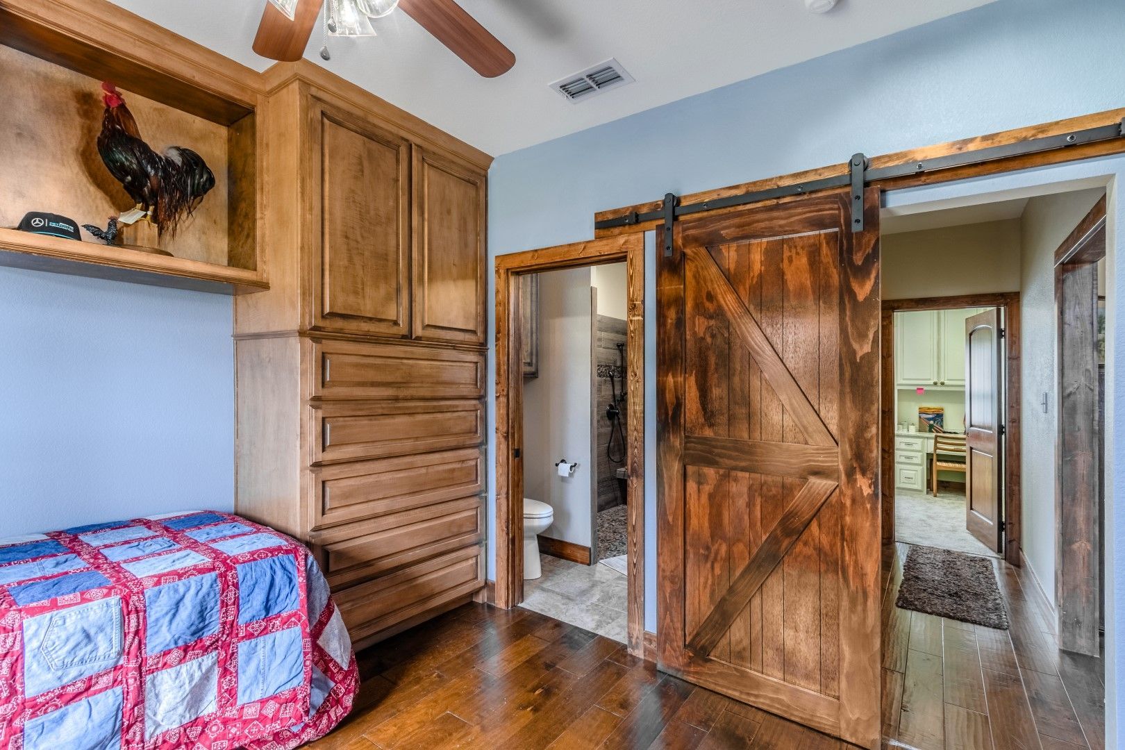 a bedroom with a sliding barn door and a bathroom