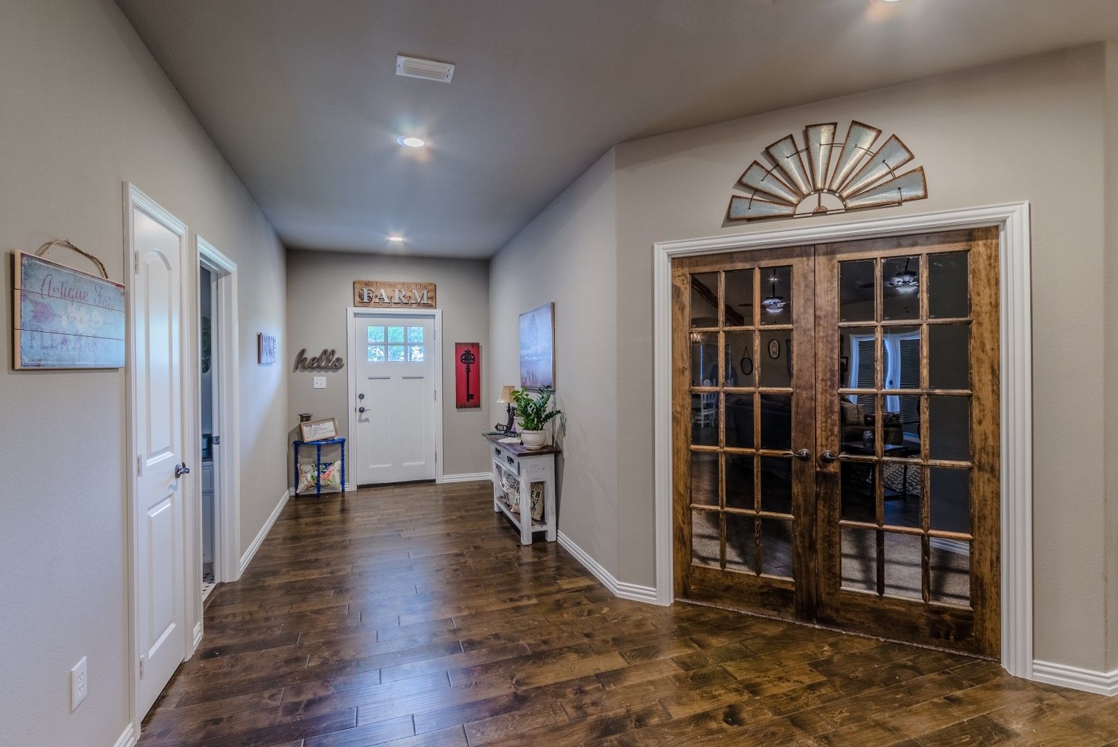 a hallway with hardwood floors and French doors