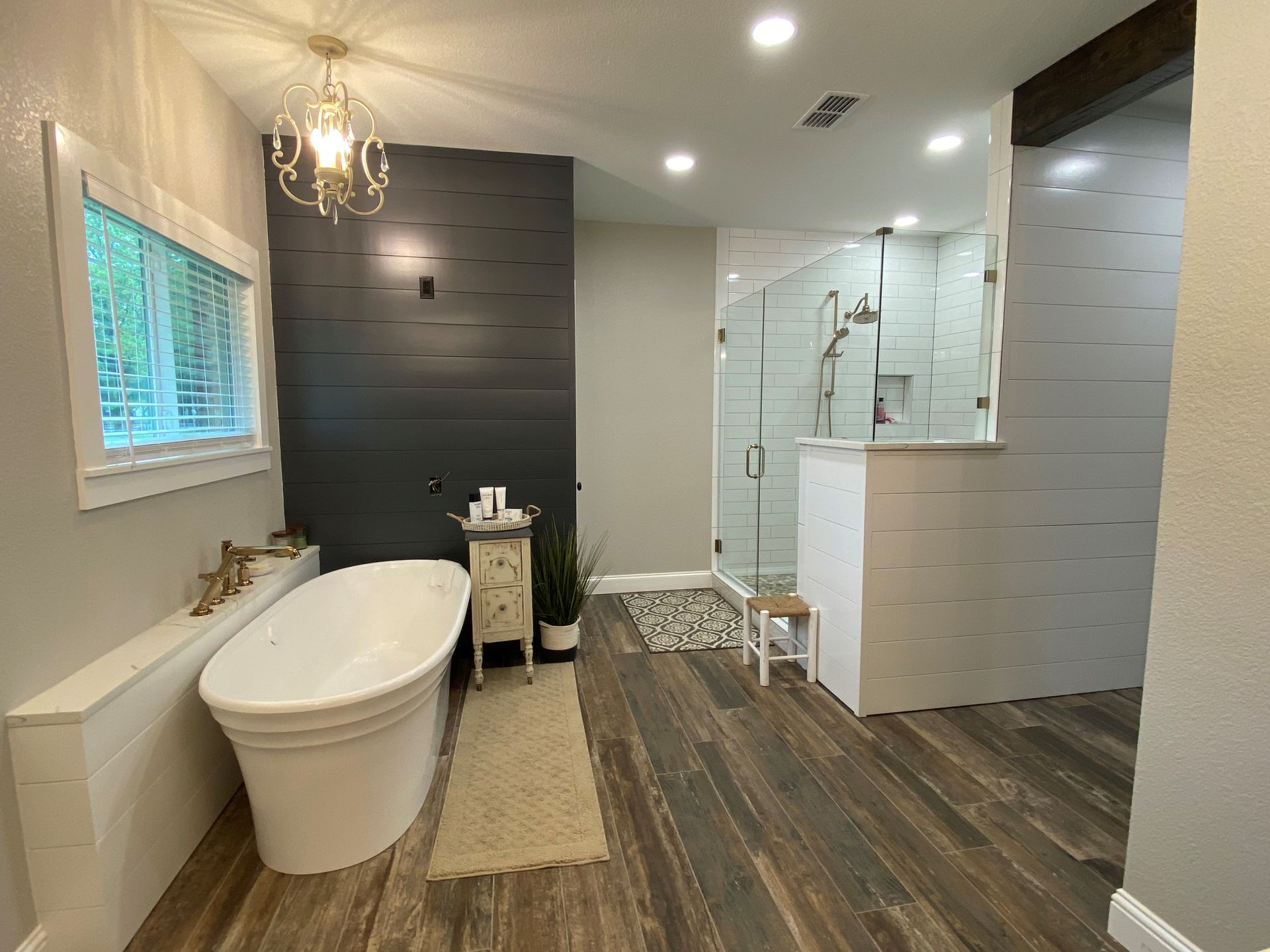 A bathroom with a bathtub and a shower.