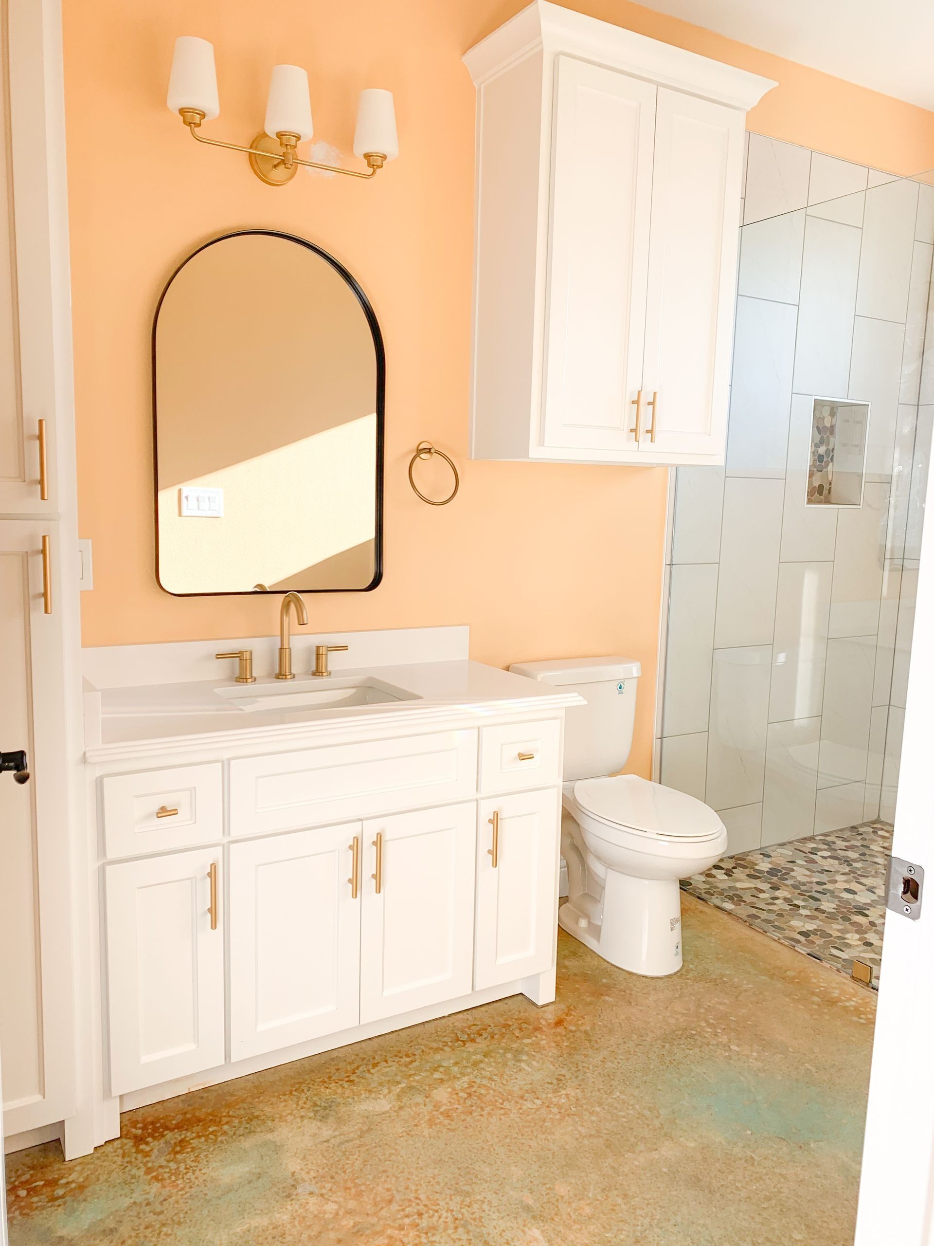 A bathroom with peach-colored walls