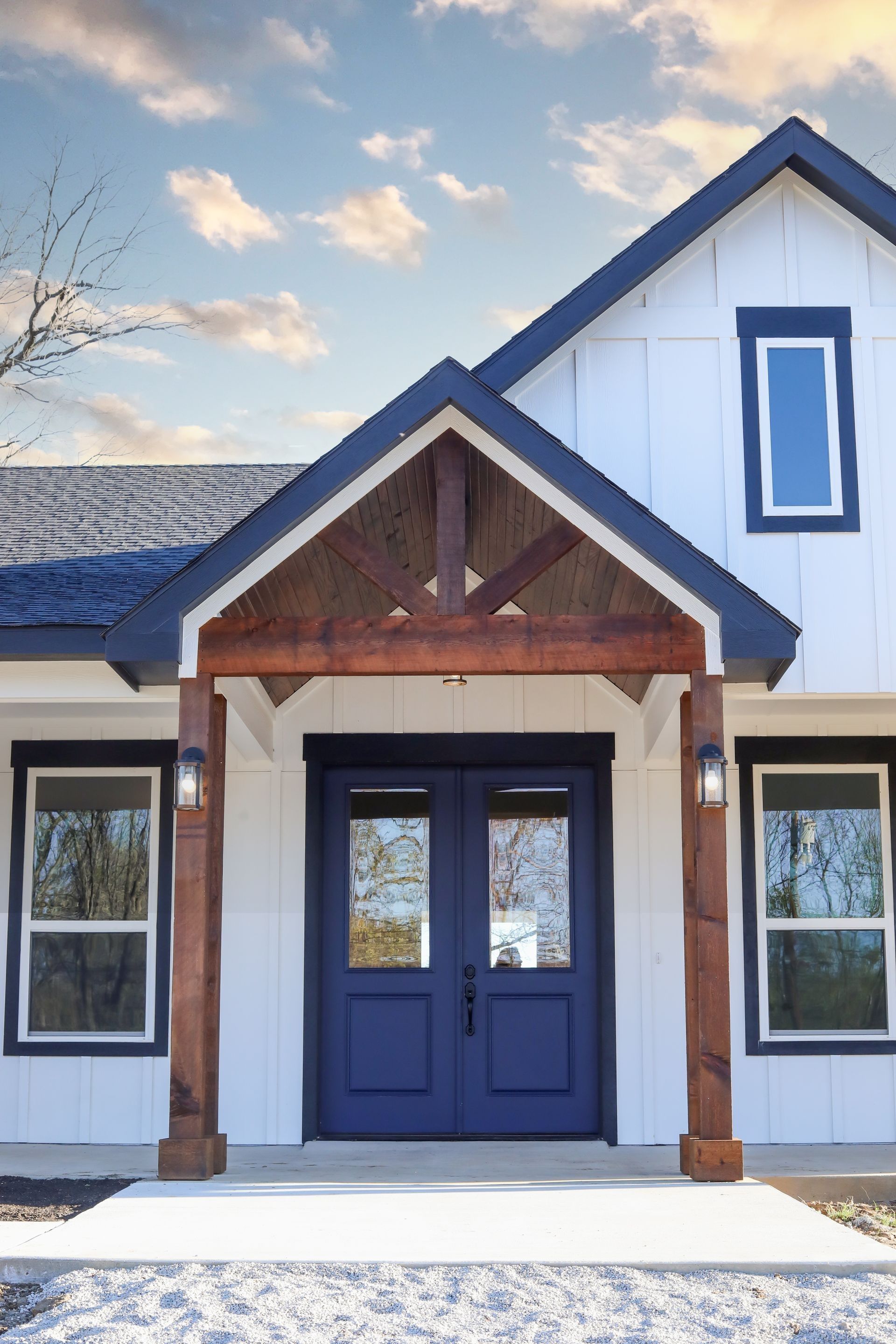 A white house with blue doors and a blue roof