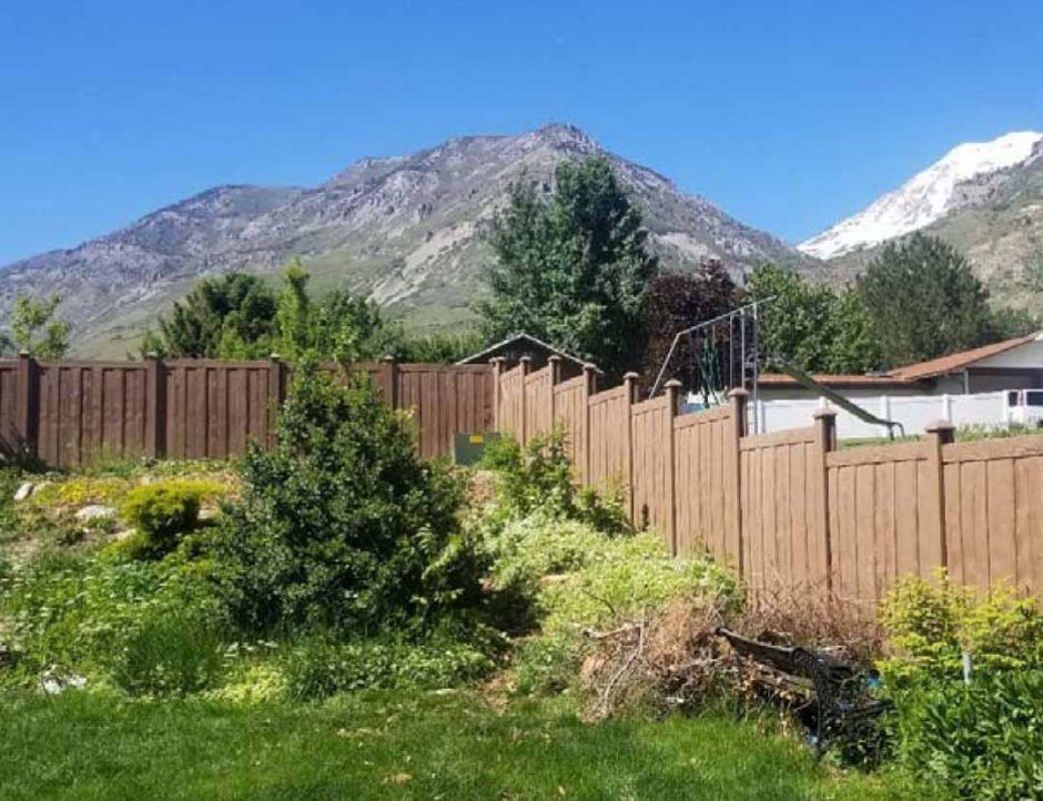 A wooden fence with a mountain in the background.