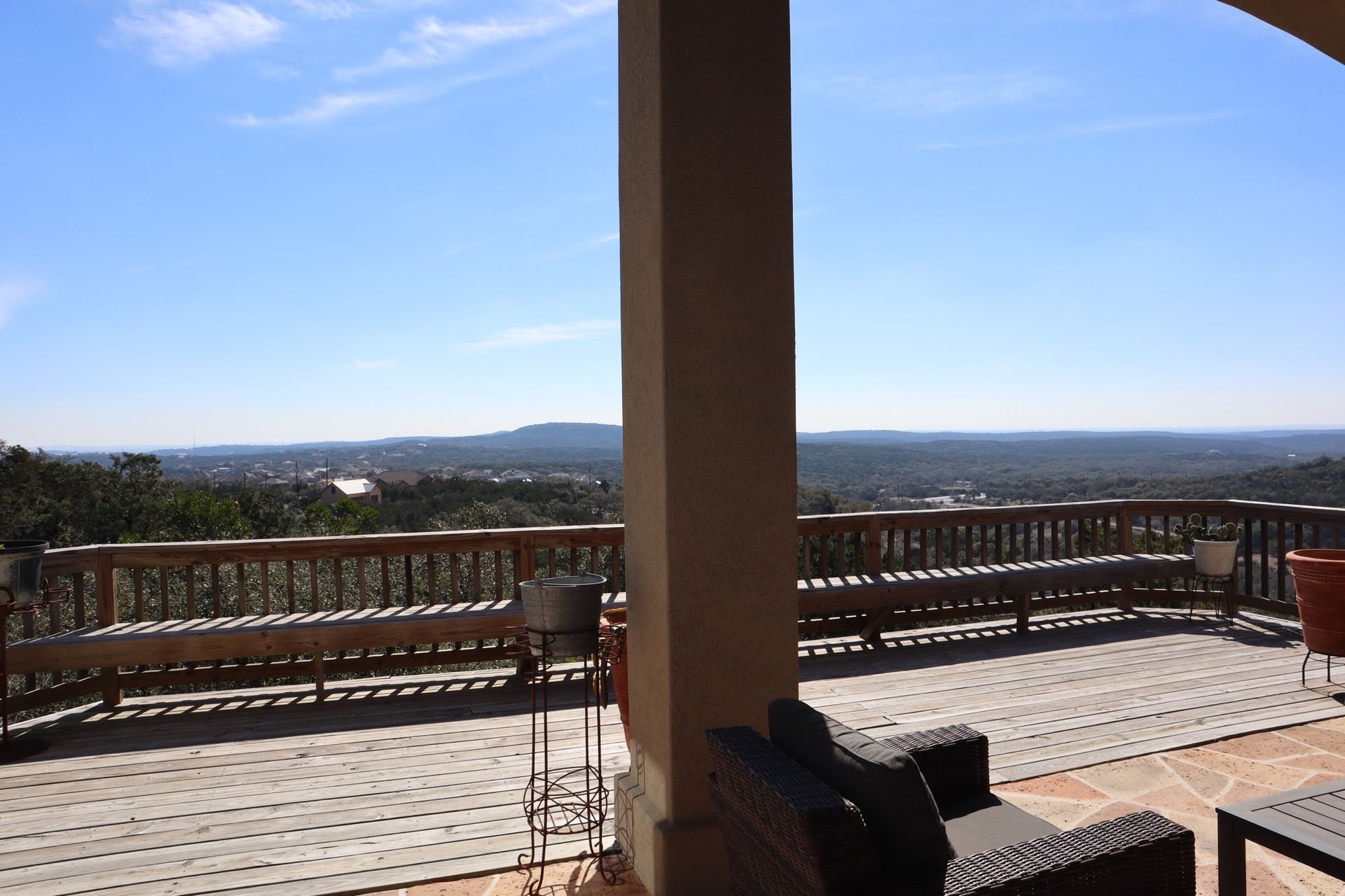a patio with a view of a city and mountains