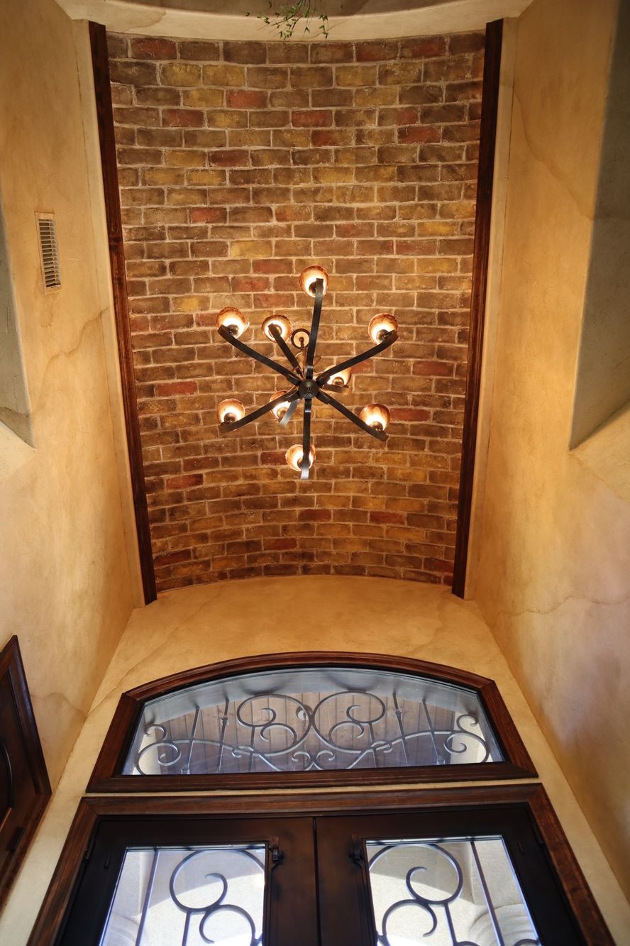 a brick wall with a chandelier hanging from it