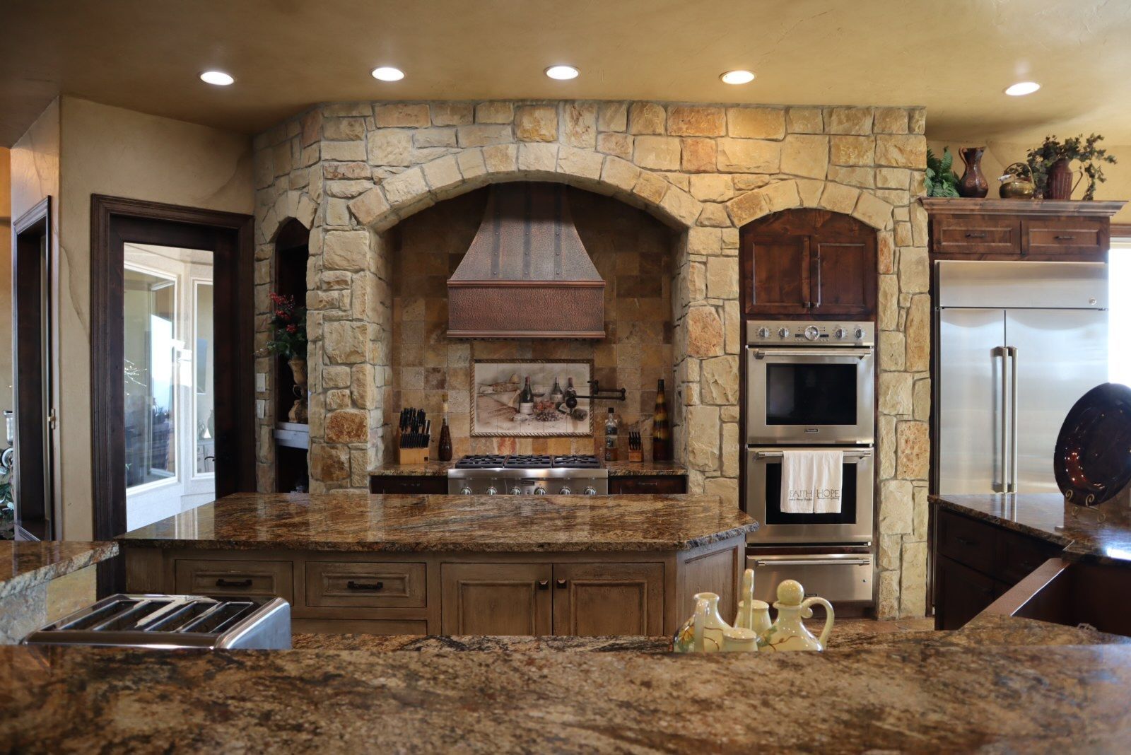 a kitchen with granite counter tops and stainless steel appliances