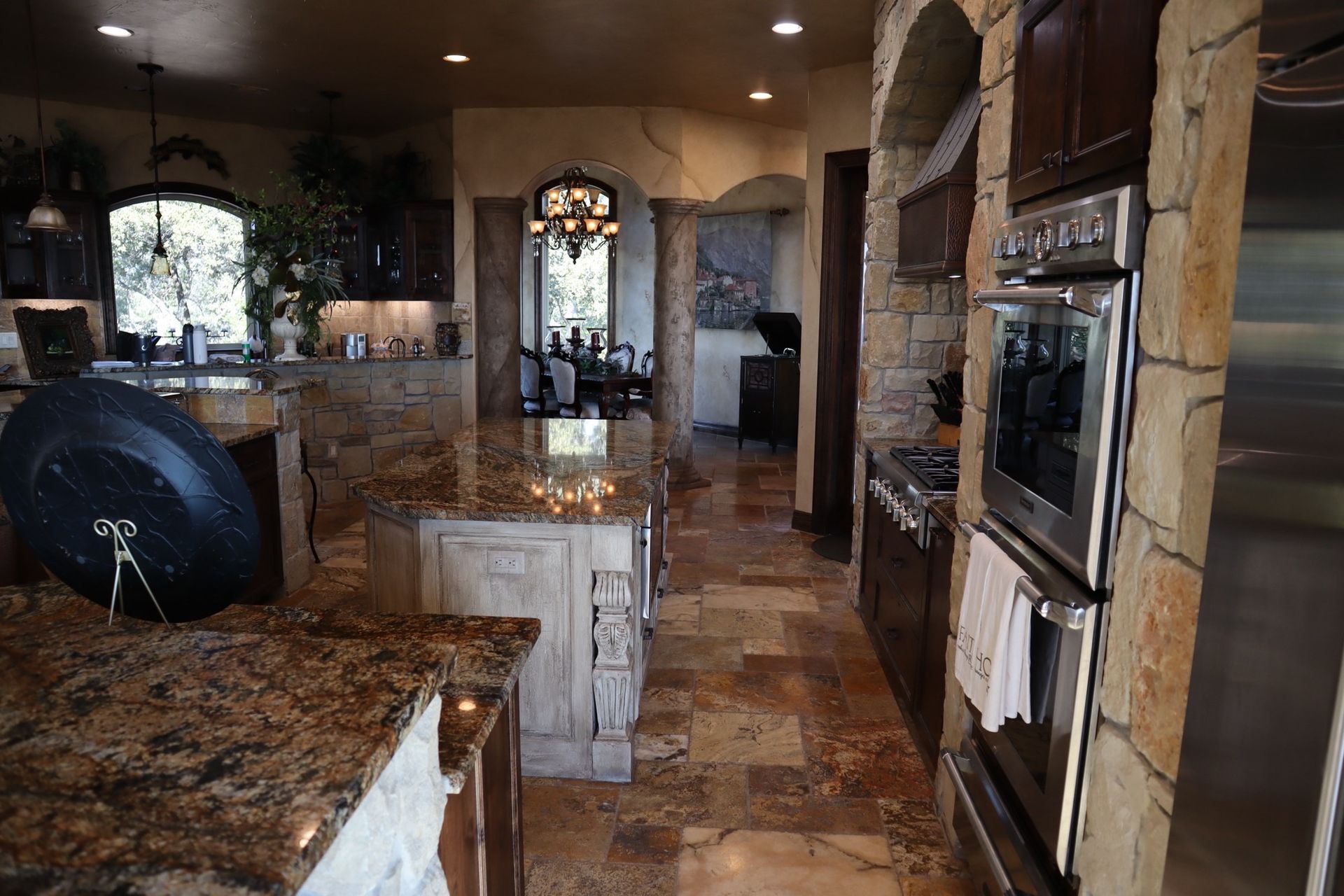 a kitchen with granite countertops and stainless steel appliances