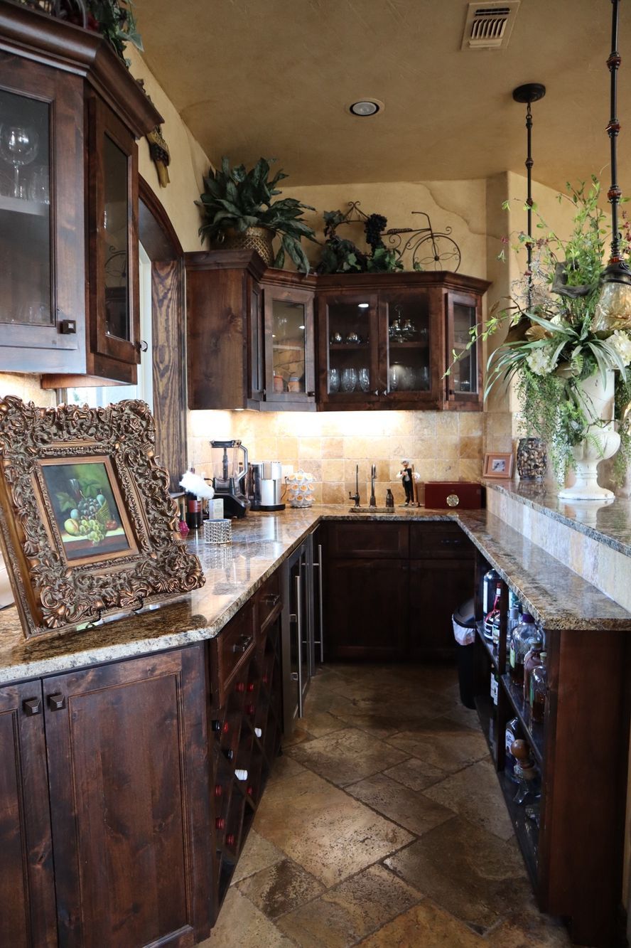 a kitchen with wooden cabinets, granite countertops, and a picture frame on the counter