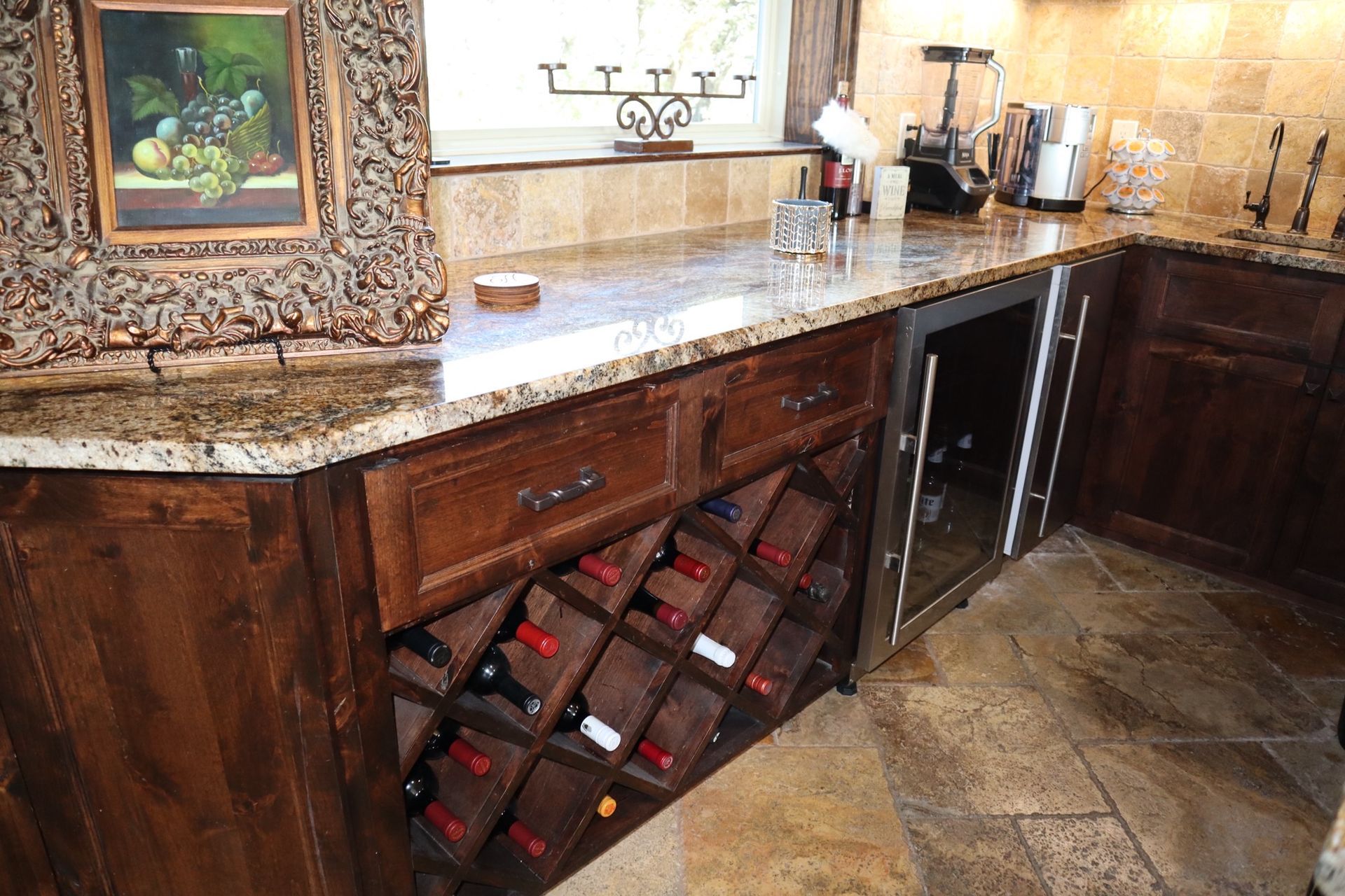 a kitchen with a wine rack and a refrigerator